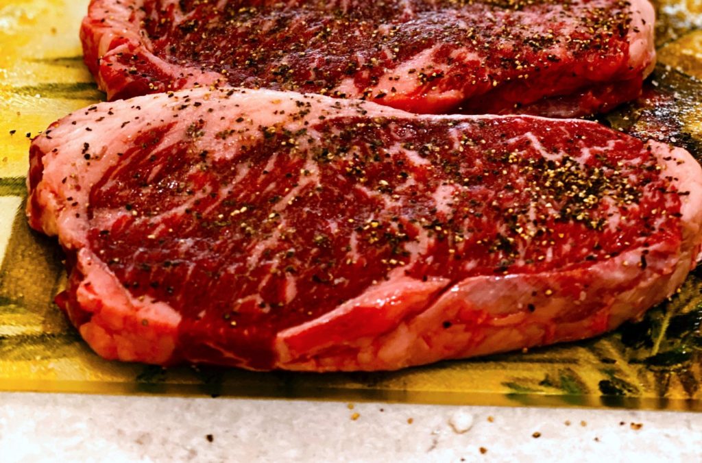 image of a steak with seasoning/rub on it