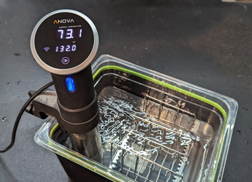 sous vide wand in a container of water