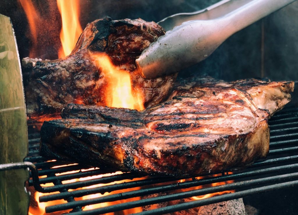 image of two steaks grilling